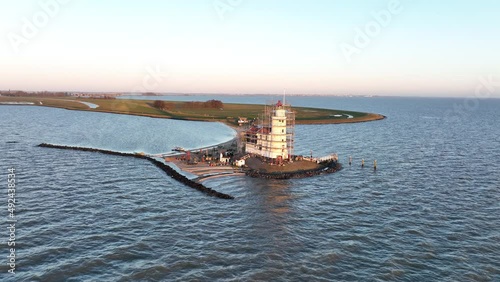 Aerial view of the Paard van Marken at sunrise traditional historic monument lighthouse on the island of Marken in The Netherlands. Small fishing village in Europe. photo