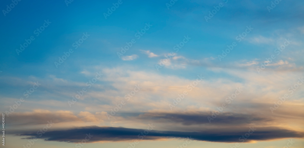 Beautiful bright sunset sky with clouds. Sky background.