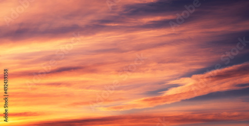 Beautiful bright sunset sky with clouds. Sky background.