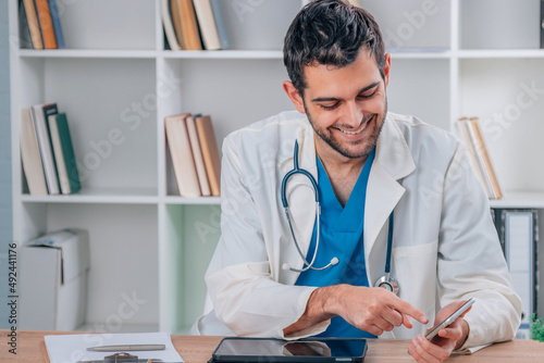 portrait of young doctor working with device