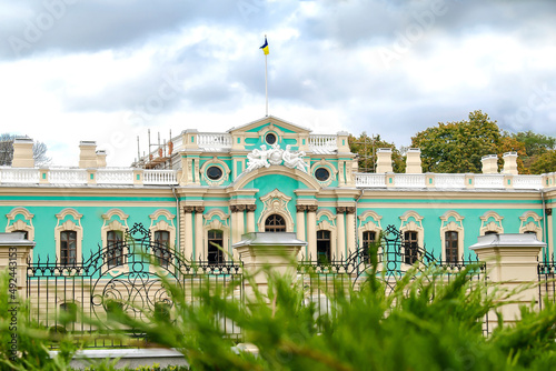 Luxury national Mariyinsky Palace building in Kiev is official ceremonial seat of the Ukrainian president with green ornamental bushes in foreground photo