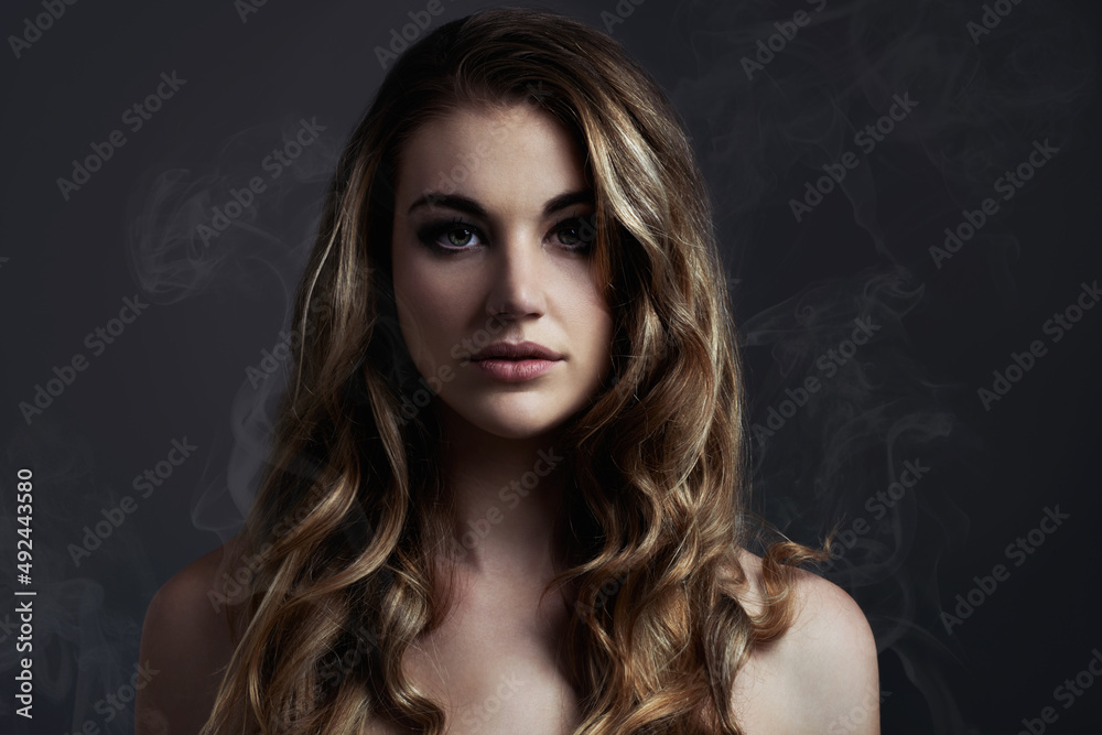 Simple and beautiful. A beautiful young woman posing in the studioStudio concept shot of a beautiful young woman with smoke coming off her.