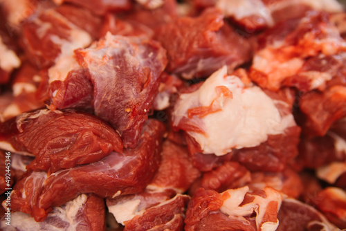 A slide of raw meat cut into pieces. Fresh beef. Preparation for cooking.