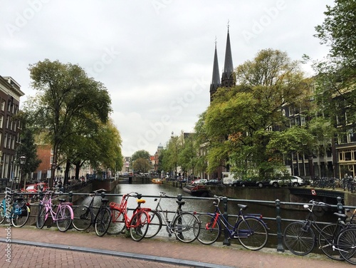 Colourful bicycles by the channel in Amsterdam, Netherlands. Early autumn. 