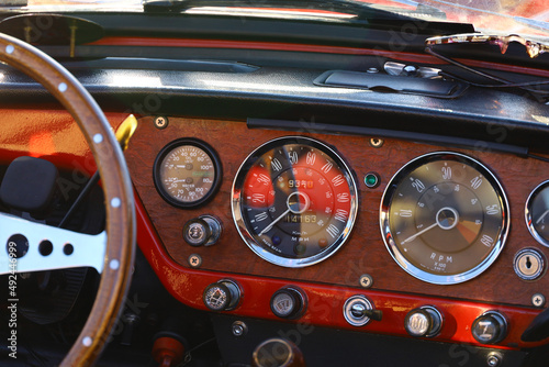 Instrument panel of a vintage car with a tasteful wood grain interior