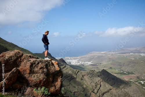 A young man admiring the beautiful views in the mountains in Gran Canaria