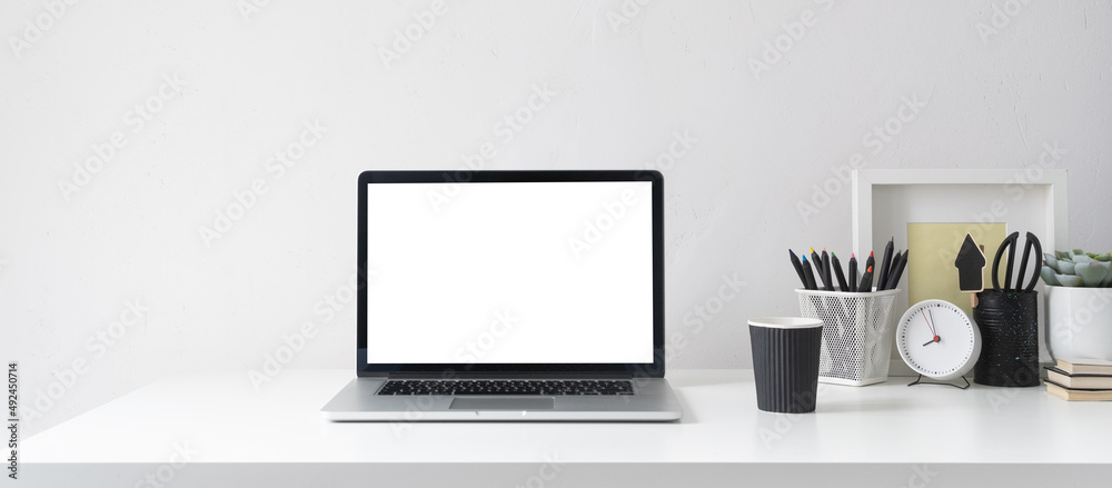 Desk with laptop screen, desk objects, office supplies, books, and plant on bright background. Desk with laptop screen, desk objects, office supplies, books, and plant on bright background.