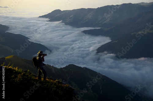 Blue sky. Cloud Sea. Photographer reminiscent of a fairy tale hero above the clouds.