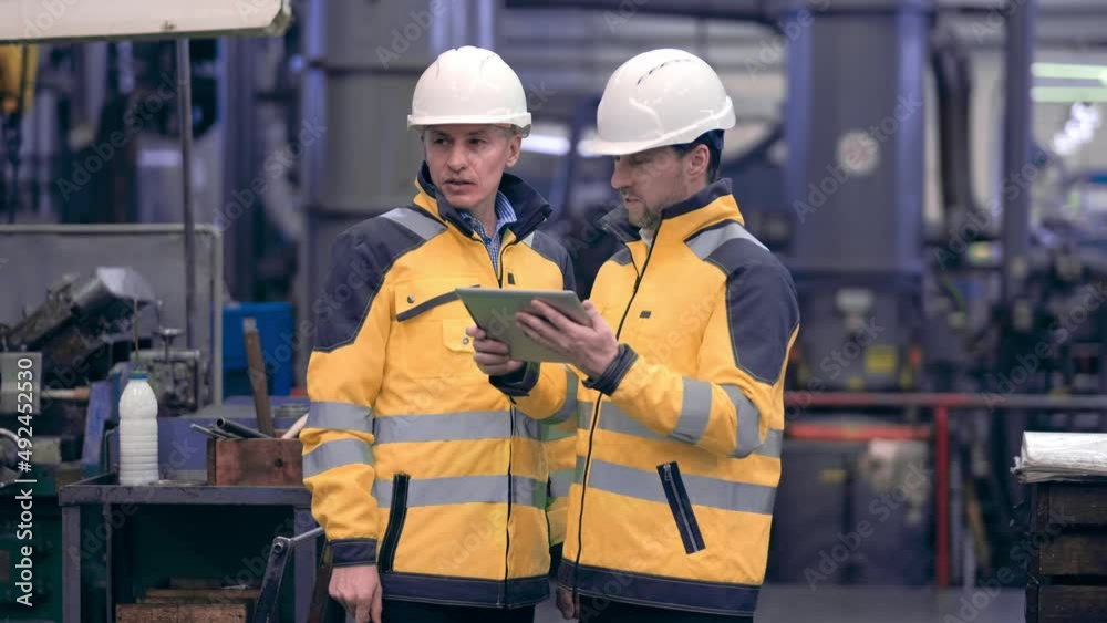 Two engineers at an industrial plant. Two workers control the work at the factory. Manufacture of cutting tools. Drill manufacturing plant. Two engineers at an industrial plant. Two workers control the work at the factory. Manufacture of cutting tools. Drill manufacturing plant.