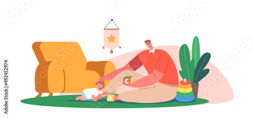 Father and Little Son Playing Toys Sitting on Floor. Happy Family Loving Relations. Man and Small Boy Gaming Fun