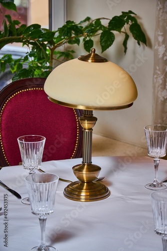 An old lamp stands on a table in a restaurant 
