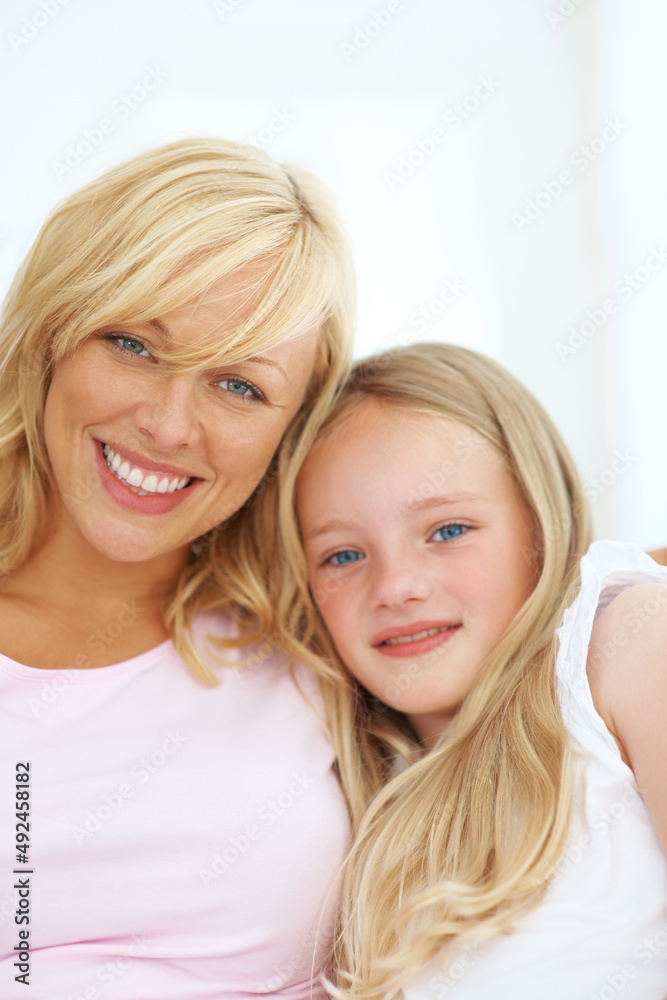 Shes such a special girl. Happy young mother sitting with her young daughter. Shes such a special girl. Happy young mother sitting with her young daughter.