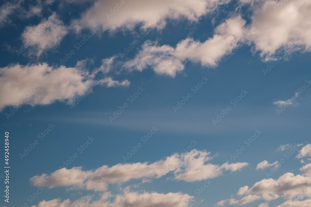 Blue sky background with big white striped clouds. blue sky panorama may use for sky replacement