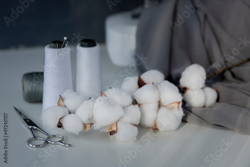 Wallpaper Mural Reels of white threads and sewing accessories. Sewing accessories on white table with natural light from the window and brunch of cotton. Torontodigital.ca