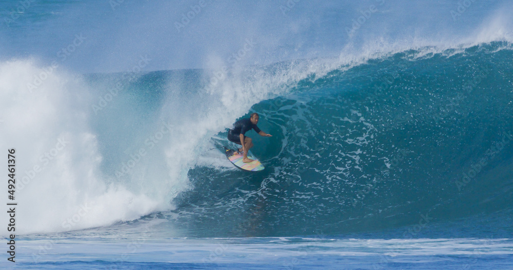 Surfer surfing big ocean barrel tube wave at Pipeline in north shore of Hawaii's Oahu island pro surfer Anthony Walsh Surfer surfing big ocean barrel tube wave at Pipeline in north shore of Hawaii's Oahu island pro surfer Anthony Walsh