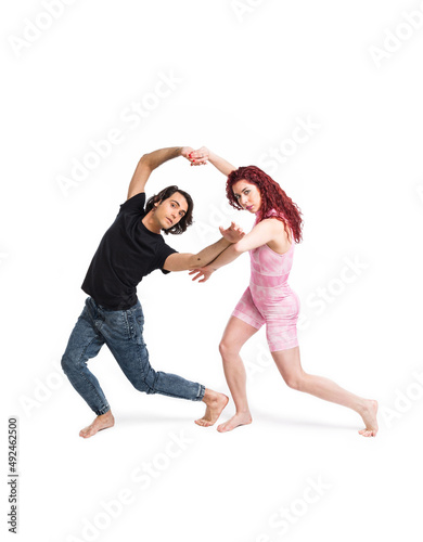 Boy and girl dancing on white background