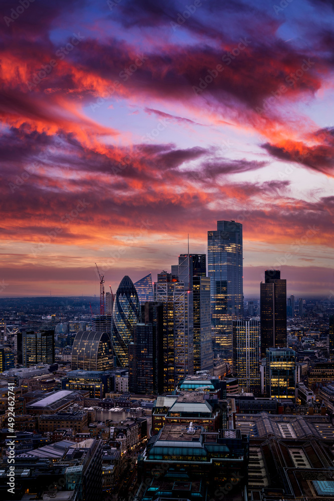 Obraz premium The highrise skyscrapers at the City of London during a colorful evening just after sunset, England, United Kingdom