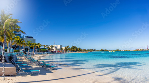 Panoramic view of the beautiful Western Esplanade Beach at Nassau, Bahamas, with calm, turquoise sea and palm trees