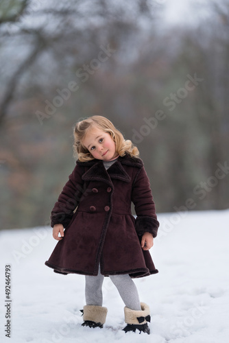 A girl in a coat on a winter snowy background
