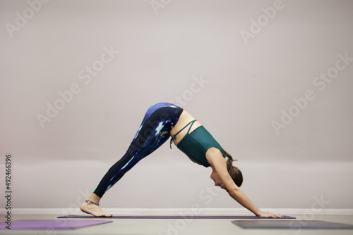 Fitness instructor practicing yoga. Fit girl exercise stretching poses..
