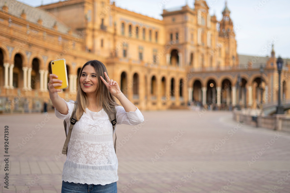 young traveler woman doing a selfie during her travel experience