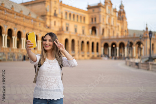 young traveler woman doing a selfie during her travel experience