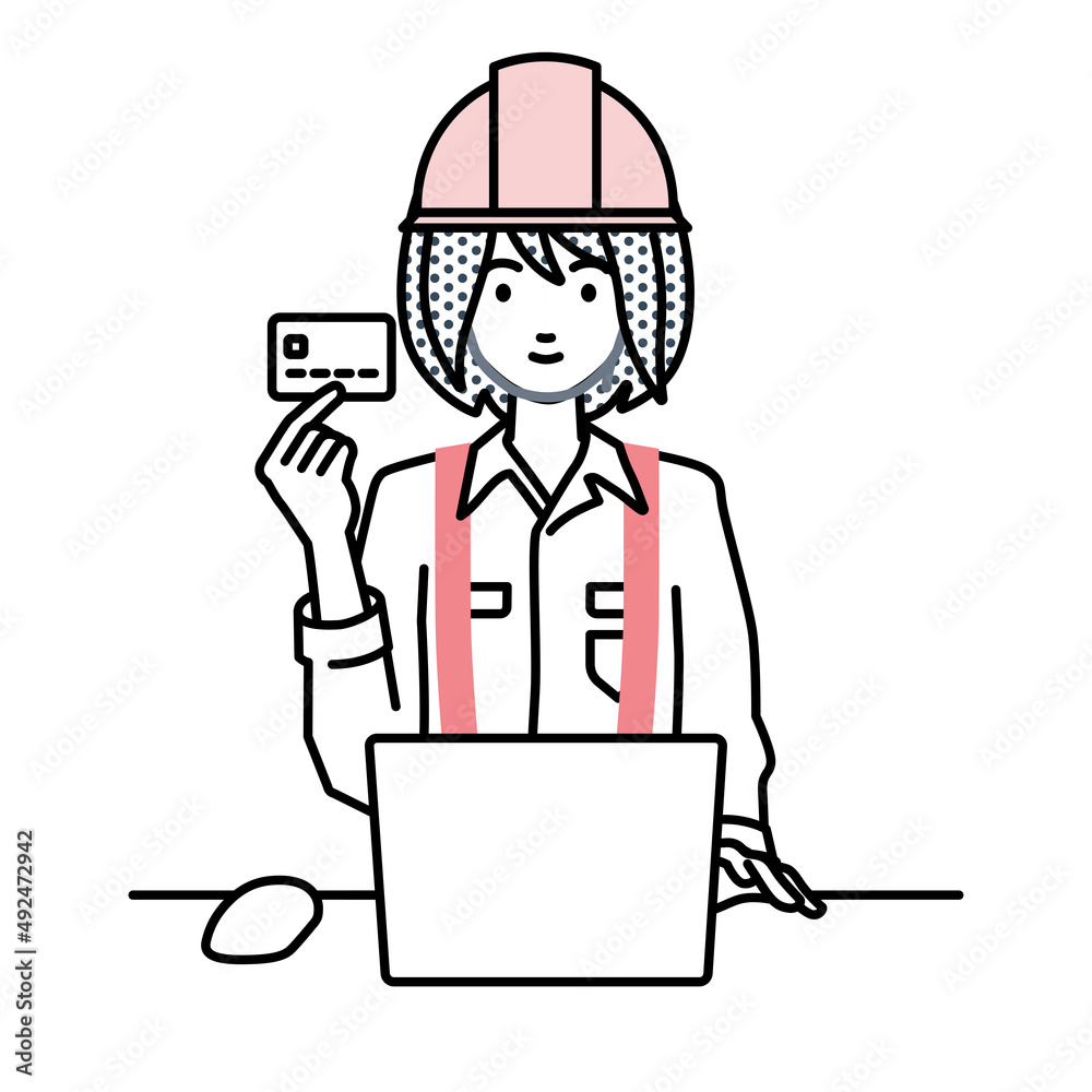 デスクで座ってPCを使いながらクレジットカードを手に持っている工事現場の女性 デスクで座ってPCを使いながらクレジットカードを手に持っている工事現場の女性