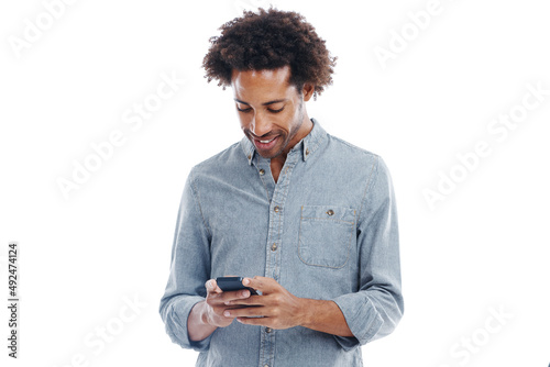 Cant wait for the next text. Studio shot of a handsome man using his mobile phone isolated on white.