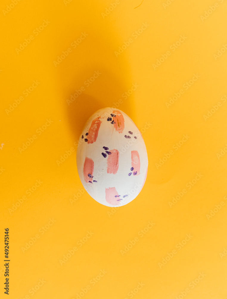 Easter egg handmade painted with modern design in yellow background