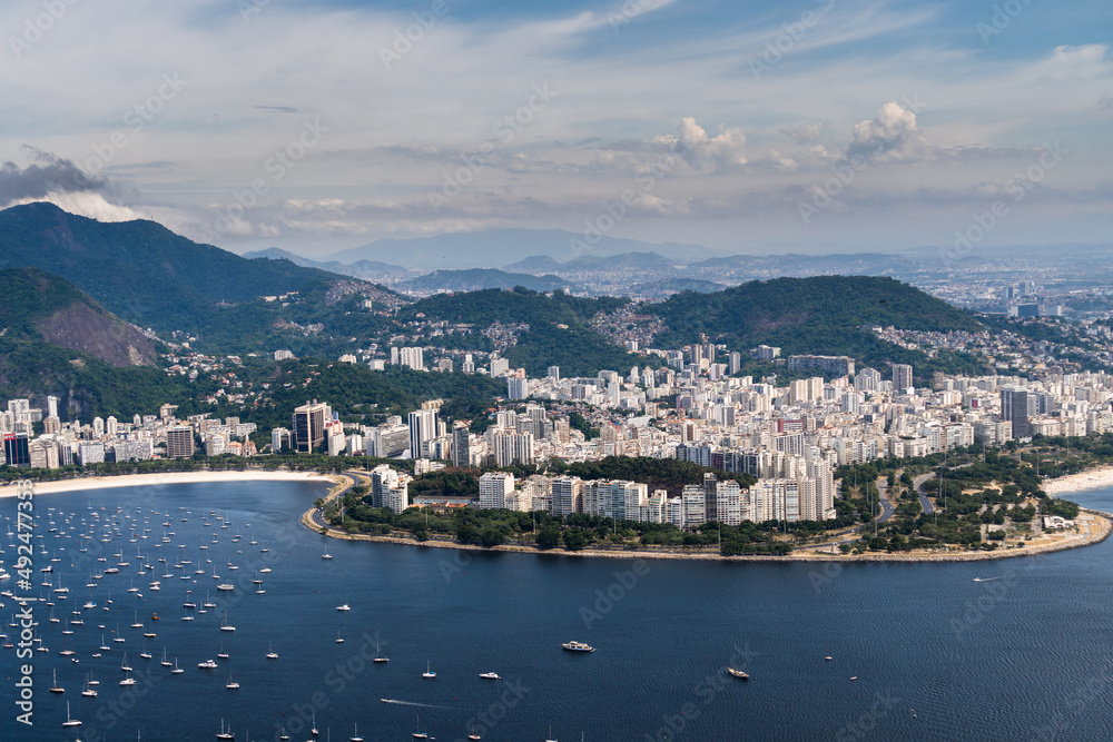 Aerial image of Botafogo and Flamengo cove and beach with its buildings, boats and landscape. Immensity of the city of Rio de Janeiro, Brazil in the background