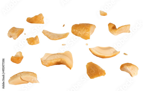 Cashew crushed into many pieces close-up isolated on white background