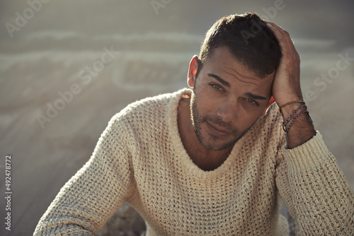 Rugged and handsome. A ruggedly handsome young man enjoying the beach.