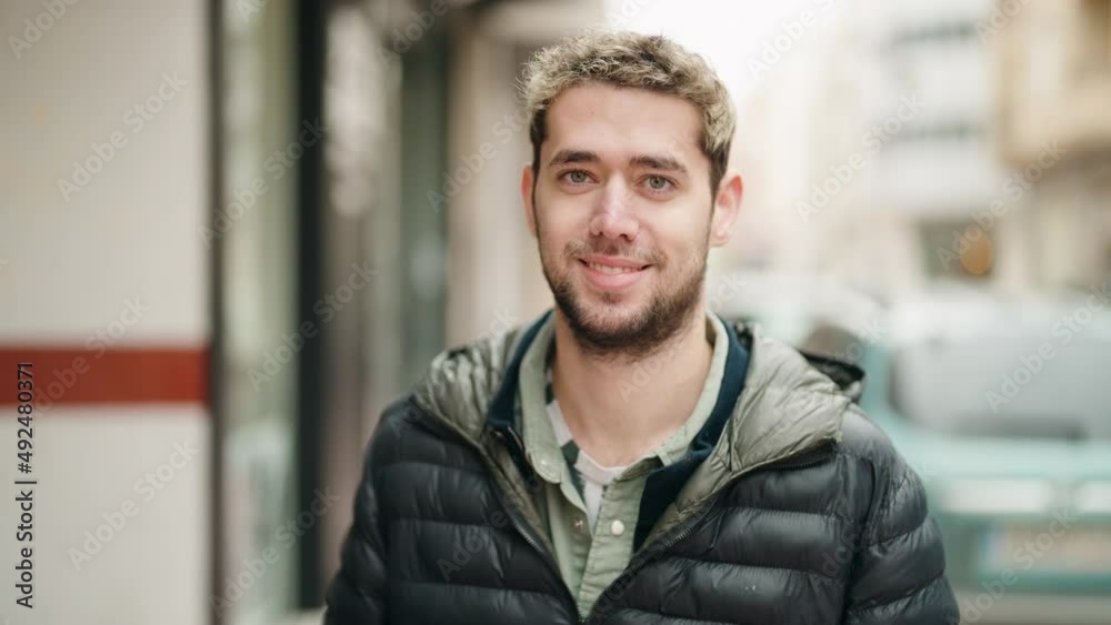 Young man smiling confident standing at street Young man smiling confident standing at street