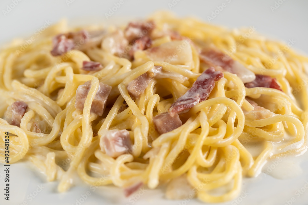 carbonara spaghetti with cream on white plate
