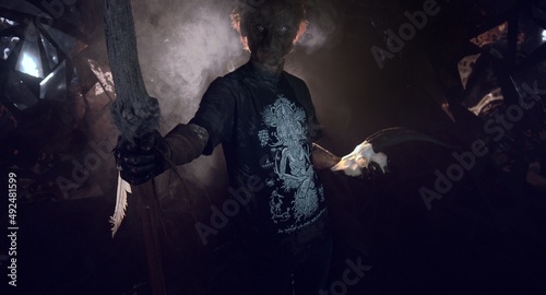 scary sorcerer in smoke. voodoo rite © Sergey