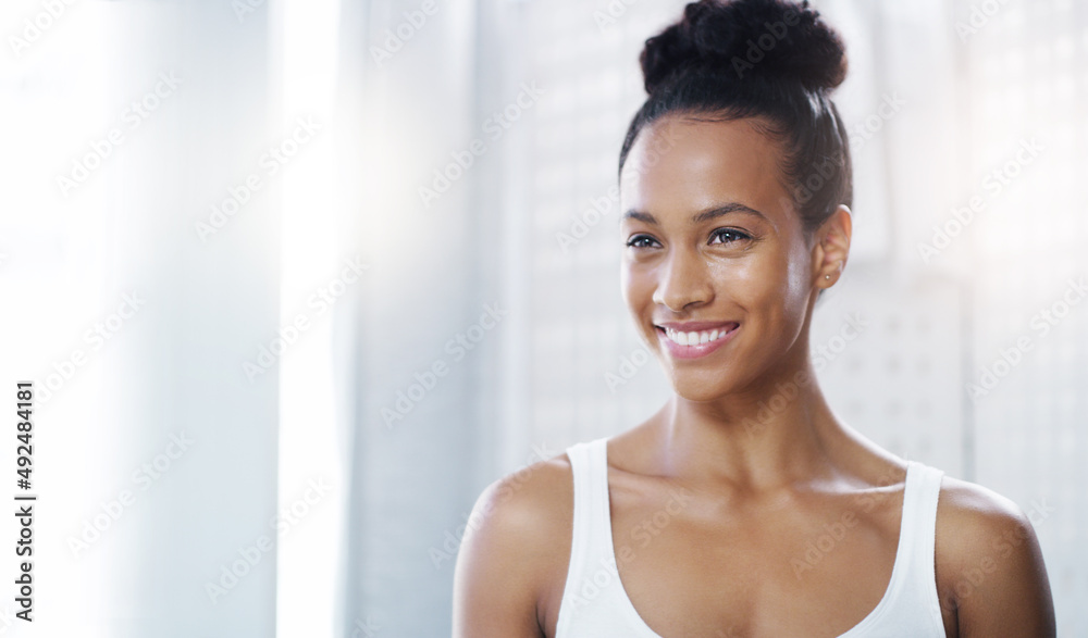 Beauty personified. Shot of an attractive young woman admiring her face in the bathroom at home. Beauty personified. Shot of an attractive young woman admiring her face in the bathroom at home.