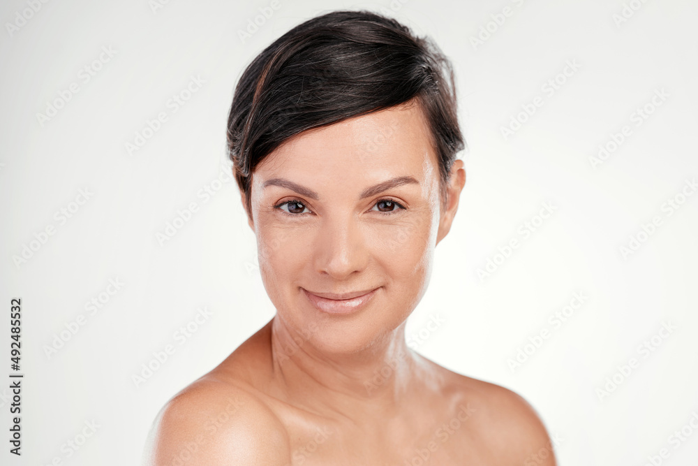 Confidence and beauty go hand in hand. Cropped portrait of a beautiful mature woman posing against a grey background in studio. Confidence and beauty go hand in hand. Cropped portrait of a beautiful mature woman posing against a grey background in studio.