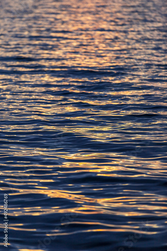 sea wave close up, low angle view. reflection of sun lights