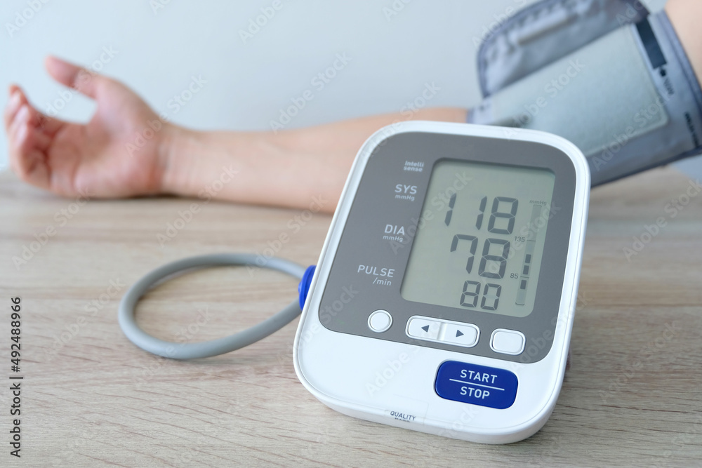 Man check blood pressure monitor and heart rate monitor with digital pressure gauge. Health care and Medical concept Man check blood pressure monitor and heart rate monitor with digital pressure gauge. Health care and Medical concept