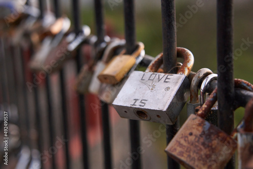Padlocks attached to a fence to symbolize the love of a couple                 