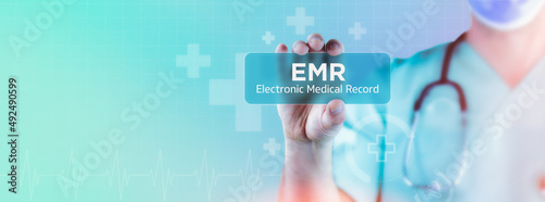 EMR (Electronic Medical Record). Doctor holds virtual card in his hand. Medicine digital