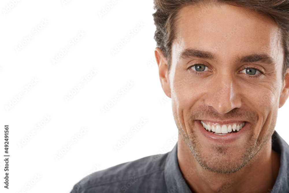 Fototapeta premium Hes so charismatic. Portrait of a handsome young man smiling against a white background.