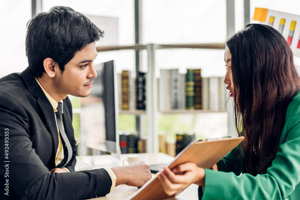 Asian business man and woman meeting analyzing and discussing strategy with startup project.Creative business people talk plan and brainstorm with document in office.Teamwork Asian business man and woman meeting analyzing and discussing strategy with startup project.Creative business people talk plan and brainstorm with document in office.Teamwork