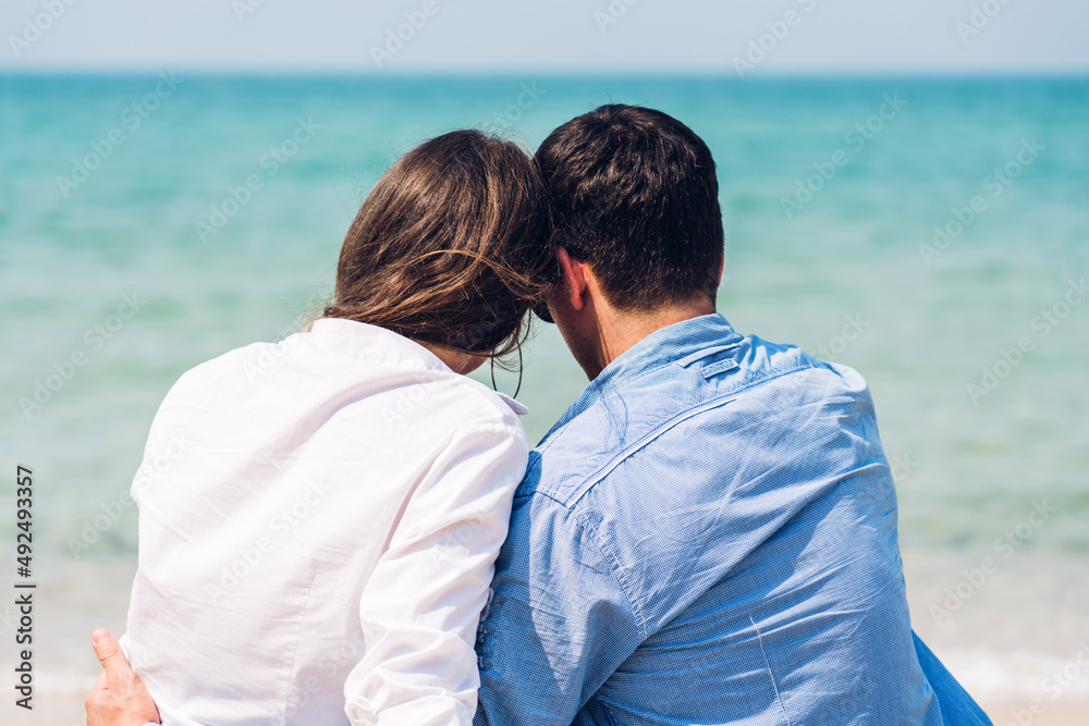 Vacation romantic love young happy smile couple in honeymoon travel holiday trip on sand at blue sky sea beach having fun and relaxing together on tropical beach.Summer travel Vacation romantic love young happy smile couple in honeymoon travel holiday trip on sand at blue sky sea beach having fun and relaxing together on tropical beach.Summer travel