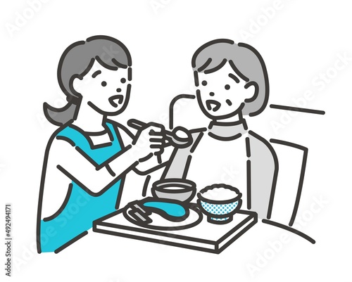 介護士（ケアマネージャー）がシニアの食事介助をするベクターイラスト素材／車椅子／高齢者／福祉士