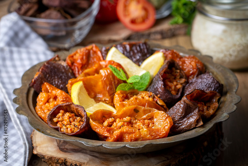 Dried eggplant stuffed and dried pepper stuffed with rice, tomato and olive oil known as dolma. (Turkish name; kuru biber dolmasi, kuru patlican dolmasi) photo