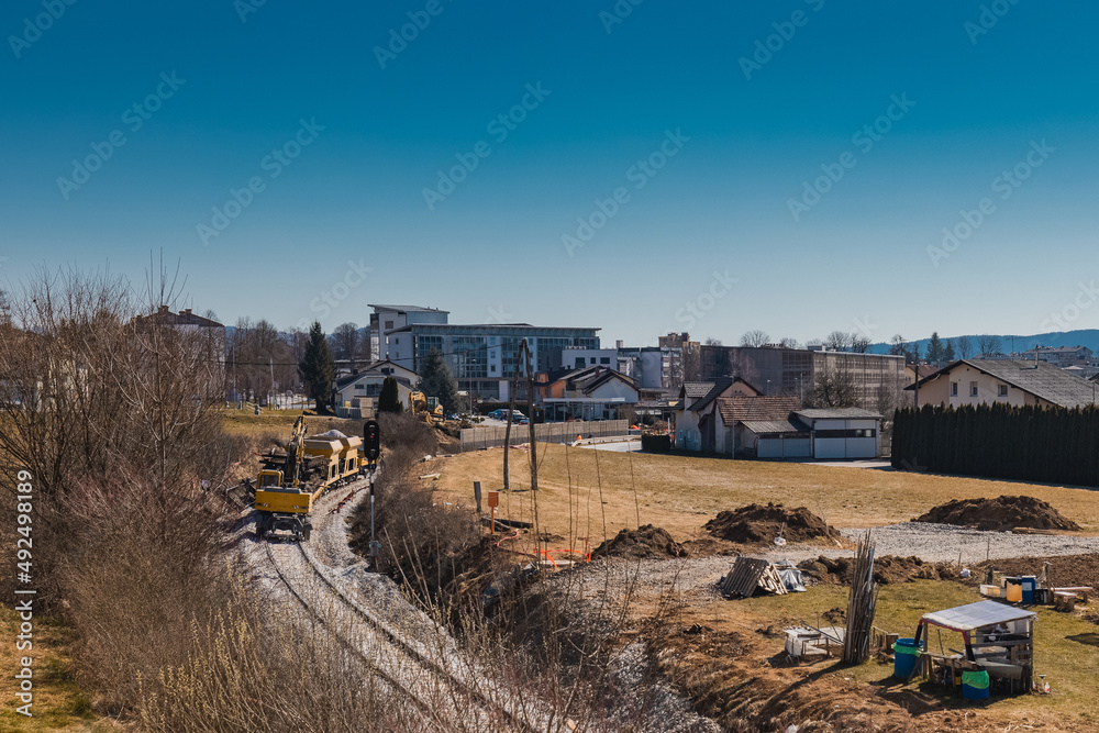 Fototapeta premium Train station of Grosuplje in Slovenia is being renovated. Visible work train parked on a siding on a sunny day.