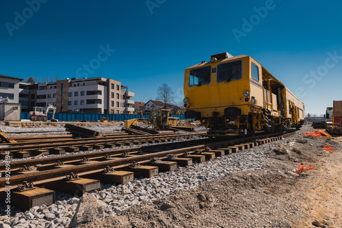 Train station of Grosuplje in Slovenia is being renovated. Visible tamper train parked on a siding on a sunny day. photo