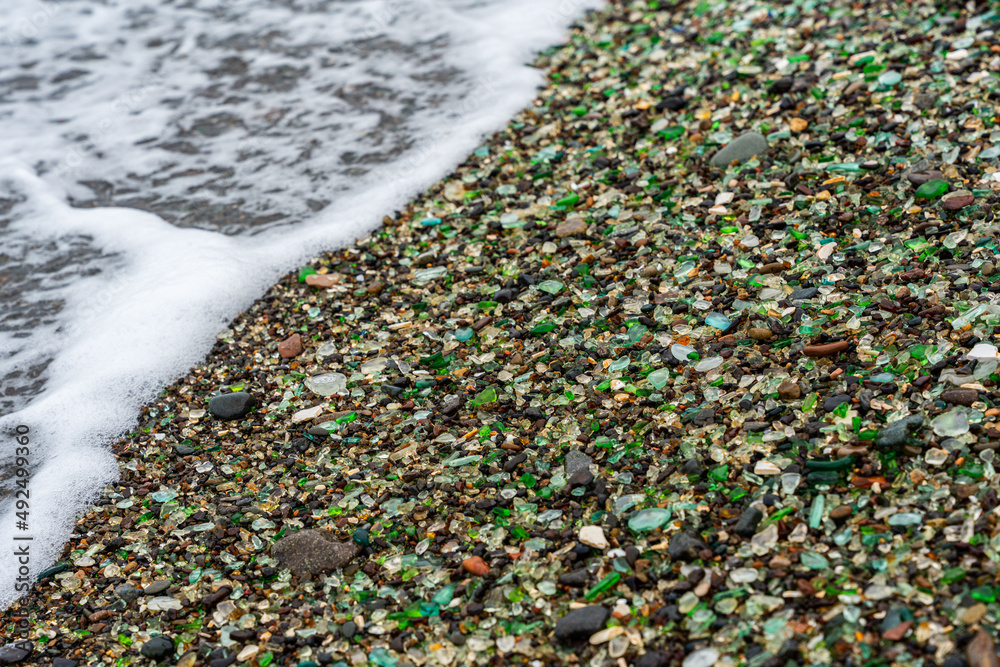 Glass Bay in Vladivostok. Sea-polished colored glass on the beach. Background, texture Glass Bay in Vladivostok. Sea-polished colored glass on the beach. Background, texture