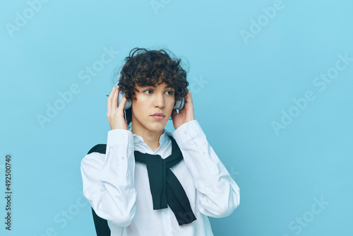 curly guy technology headphones in a white shirt with sweater Lifestyle